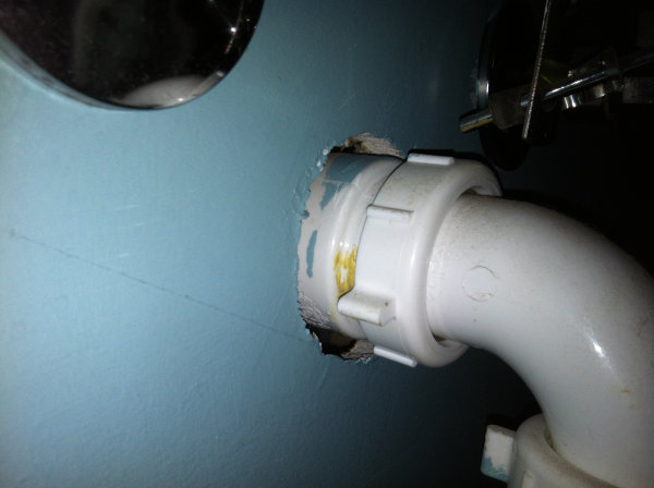Hole around a bathroom sink drain line causing air leakage