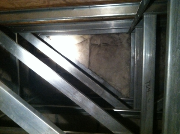 Partially insulated wall in upper attic of nursing home
